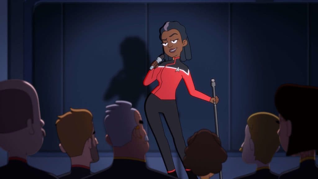 Captain Carol freeman from Star Trek:Lower Decks stands with a microphone in hand during a bad comedy set