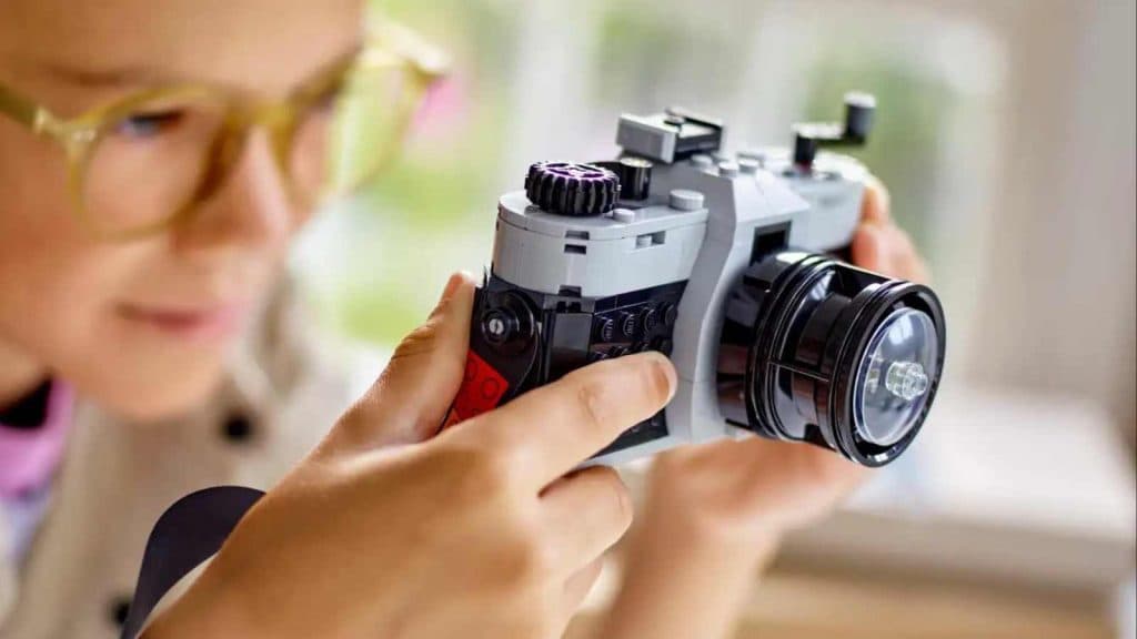 A child playing with their LEGO Creator 3in1 Retro Camera