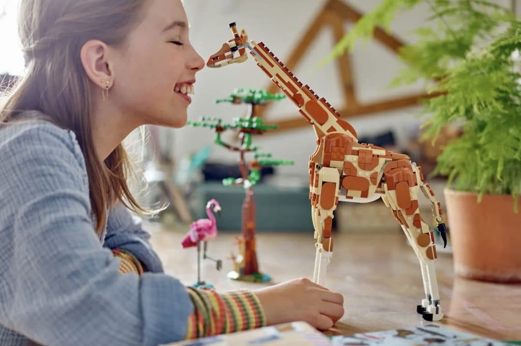 A child playing with their LEGO Creator 3in1 Wild Safari Animals set