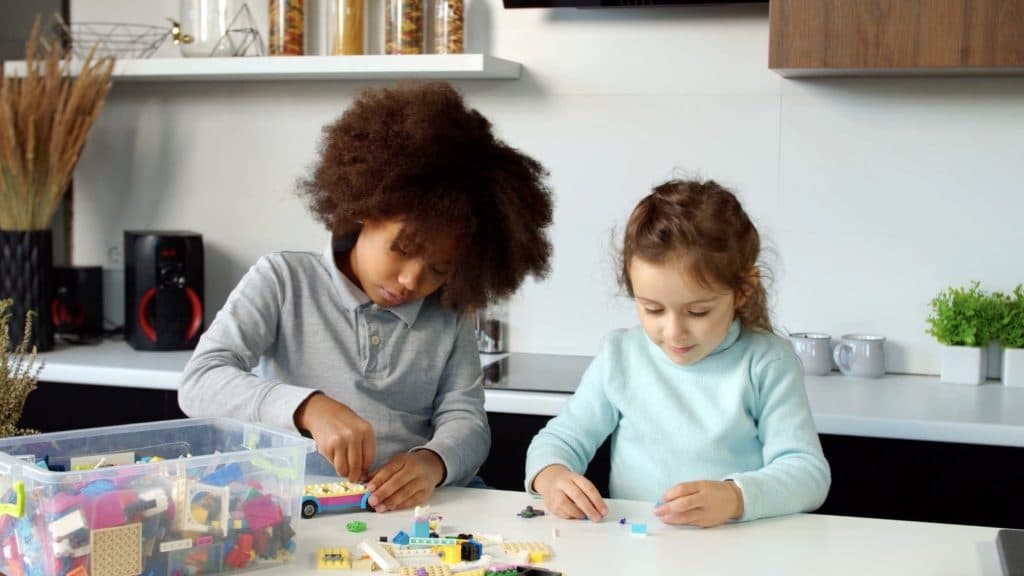 Two children playing with LEGO bricks