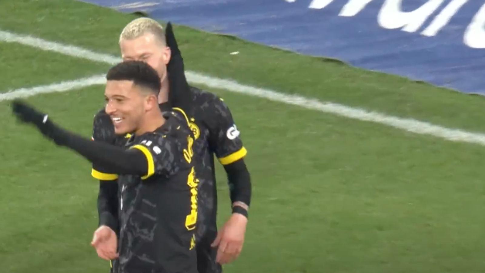 Borussia Dortmund forward Jadon Sancho celebrates with Marco Reus.
