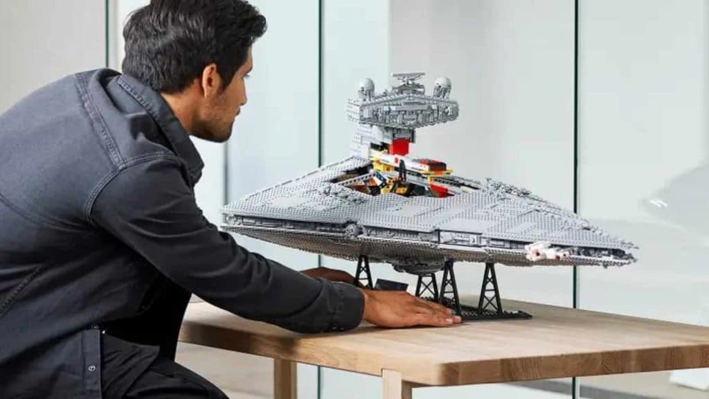 An adult admiring their LEGO-reimagined Imperial Star Destroyer