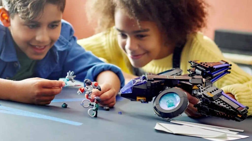 Two children playing with the LEGO Marvel Shuri’s Sunbird