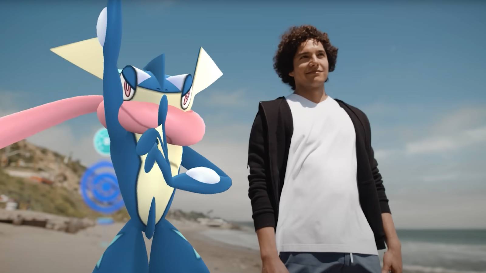 A Pokemon Go player stands next to a 3D model of Greninja