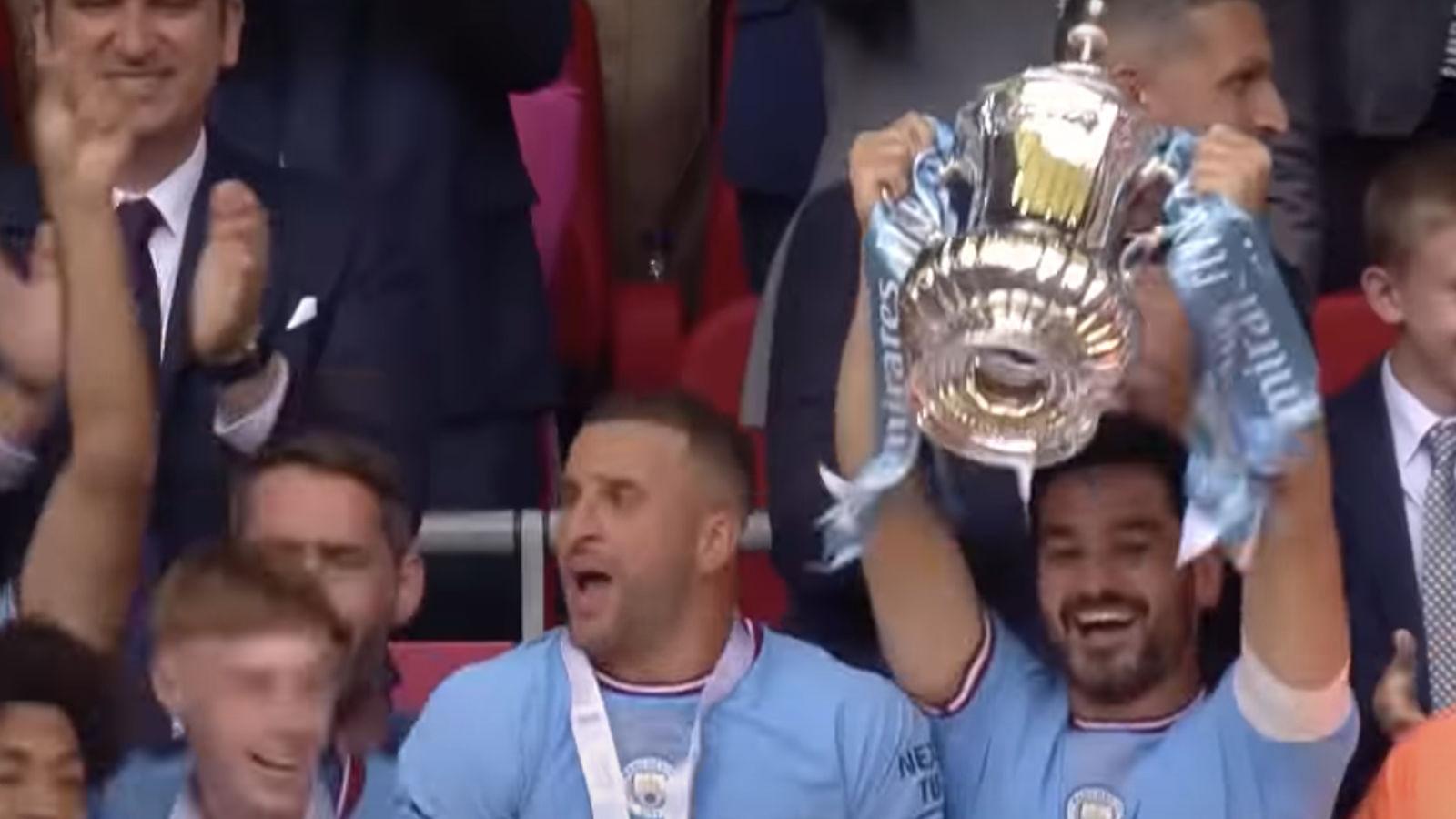 Ilkay Gundogan lifts the FA Cup trophy.