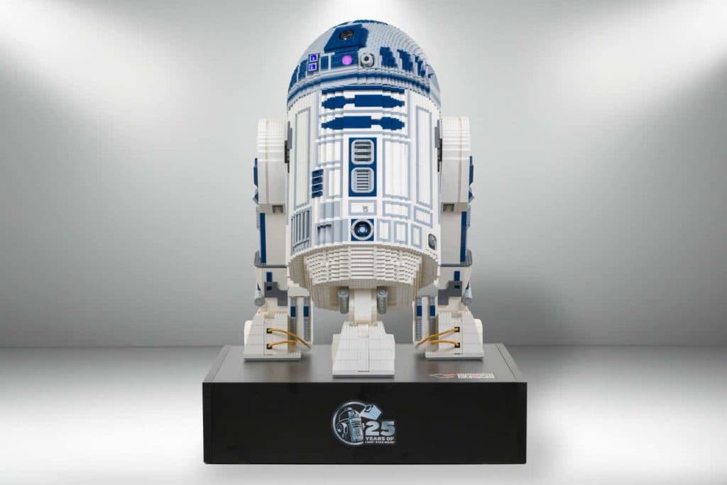 R2-D2 displayed on a stand featuring the LEGO Star Wars 25th anniversary logo.