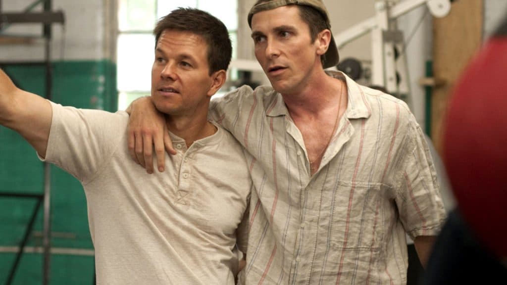 Mark Whalberg and Christian bale walk arm in arm in The Fighter