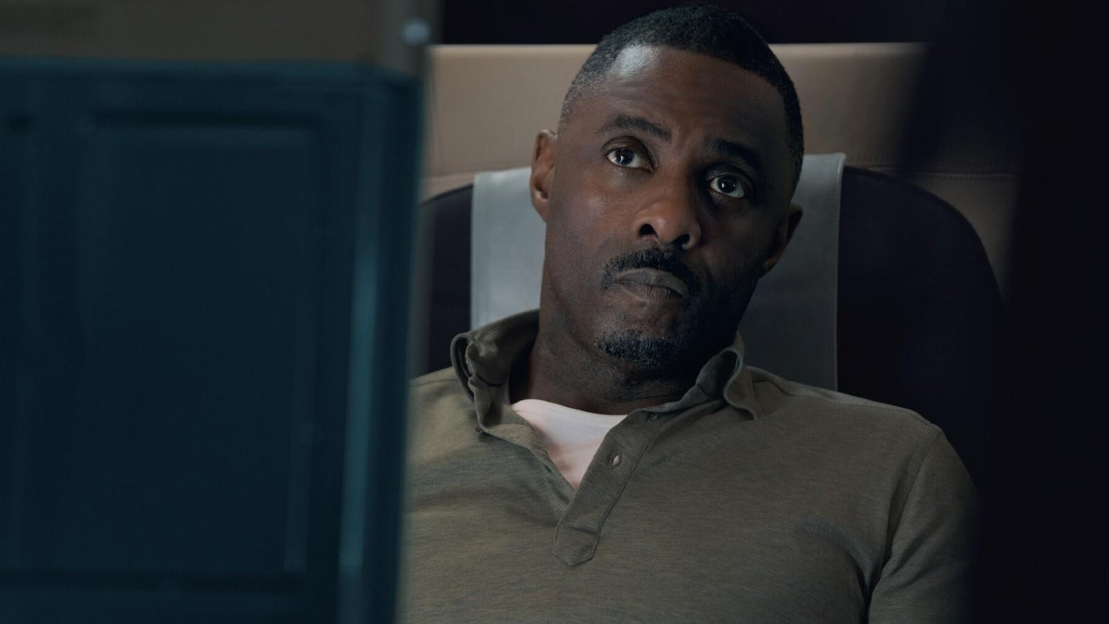 Idris Elba looking worried on a plane in Hijack.