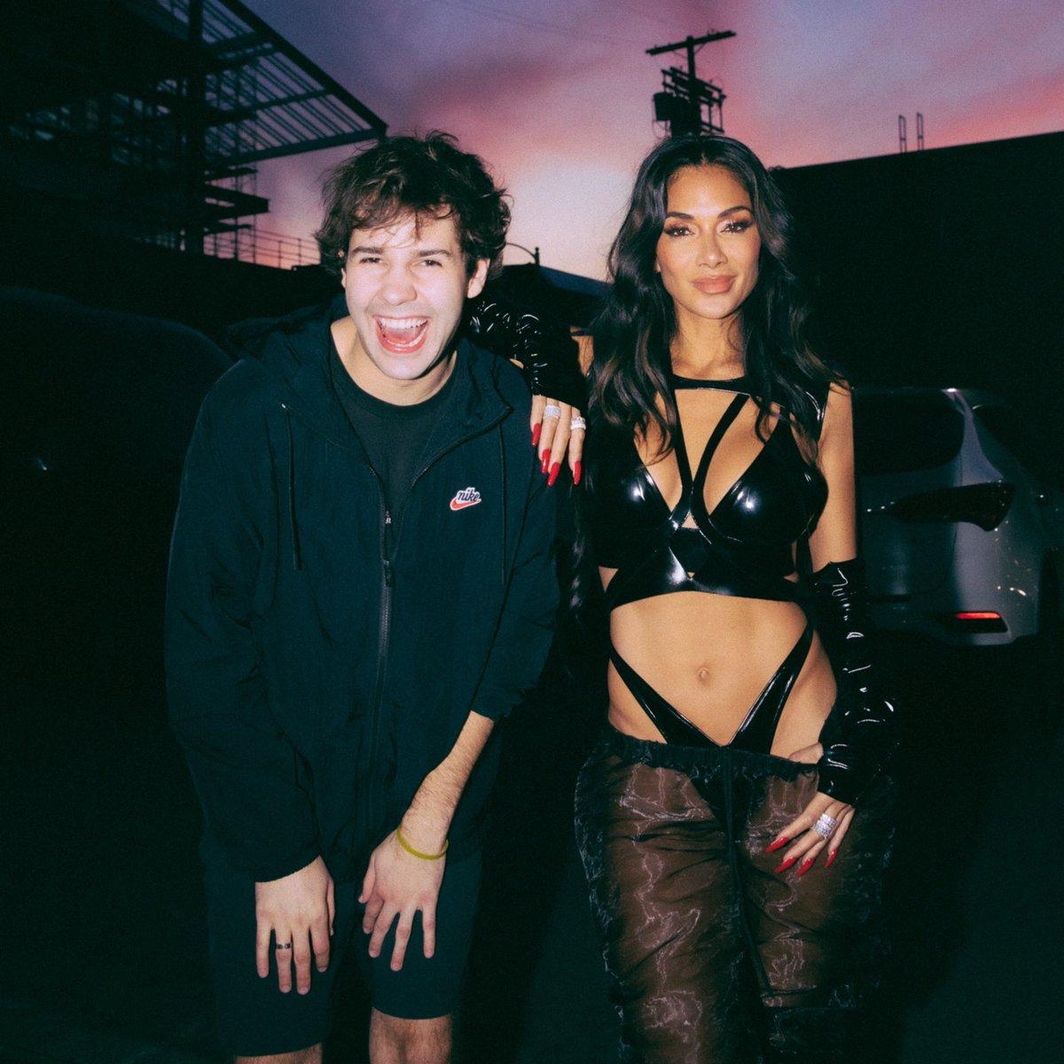 An image of David Dobrik and Nicole Scherzinger in black outfits.