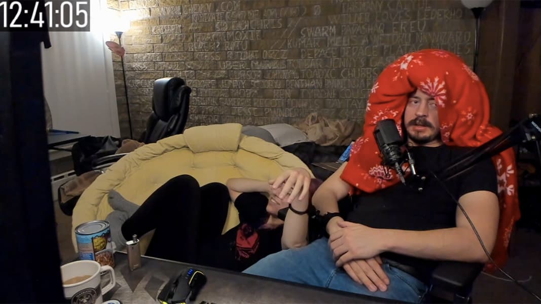 An image of two people handcuffed together during a livestream.