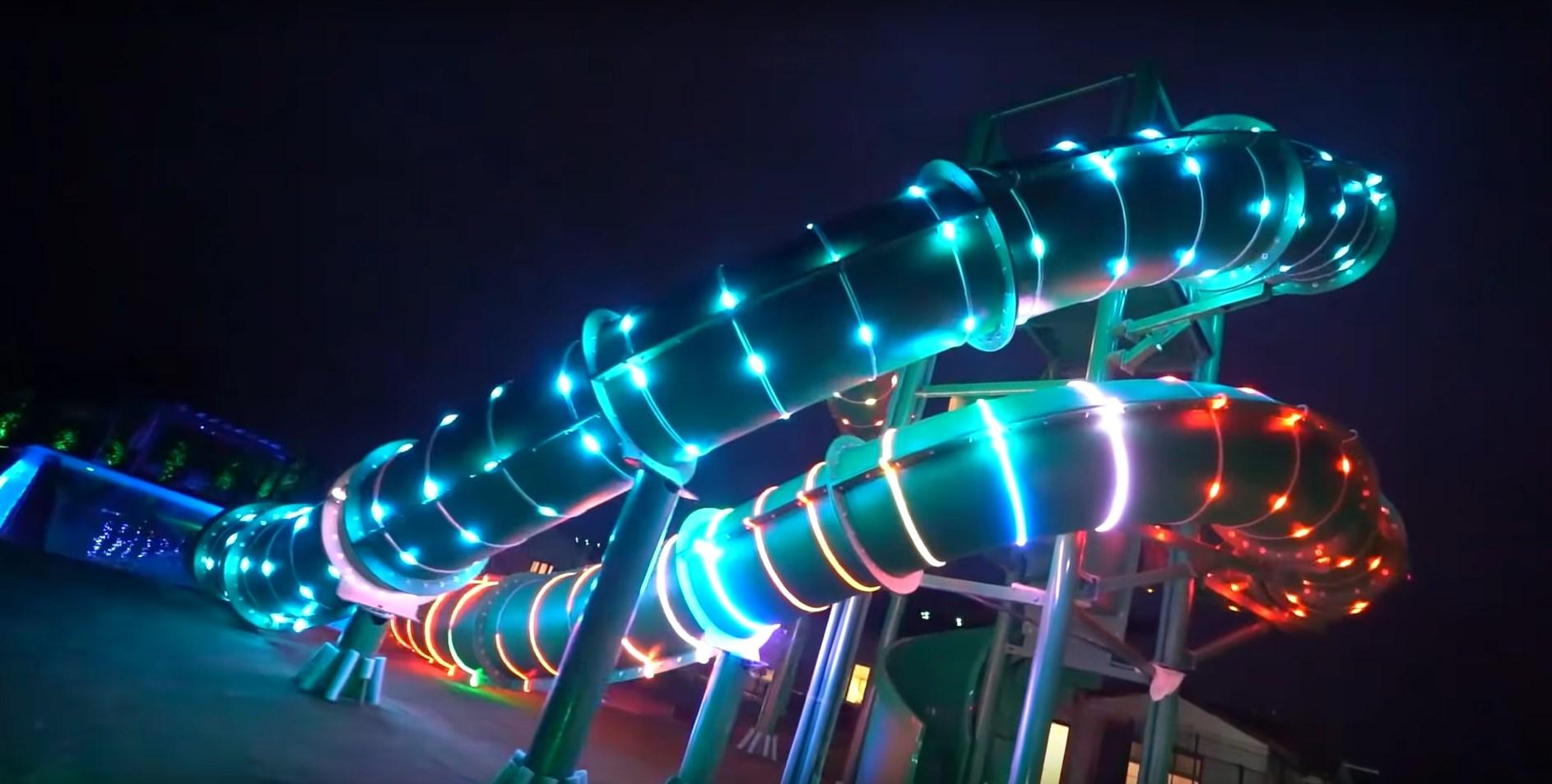 The waterslides lit up at night.