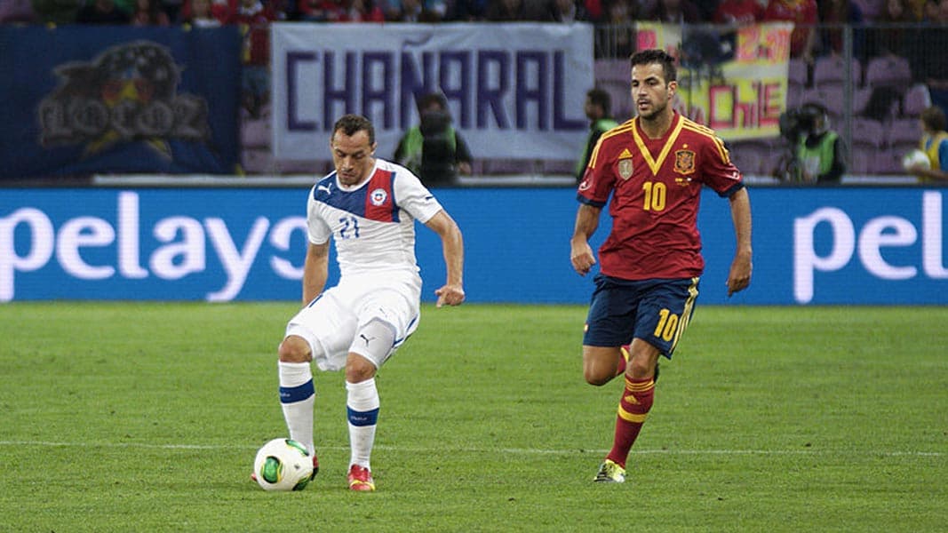 An image of Marcelo Diaz playing footbal for Chile alongside Cesc Fabregas