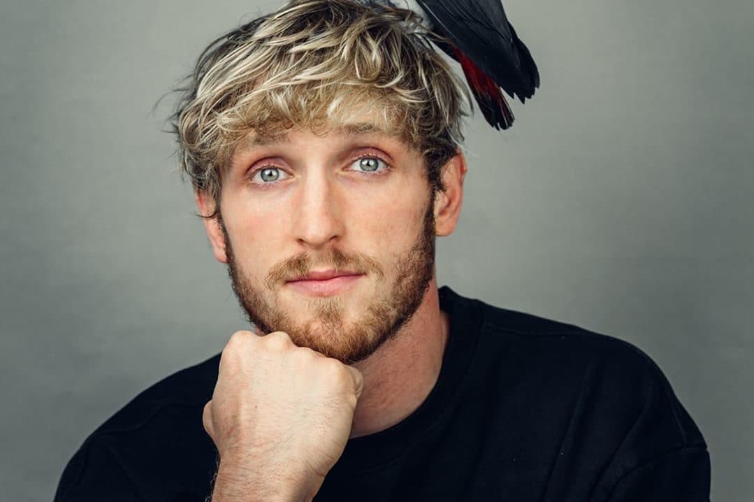 Logan Paul with parrot on head