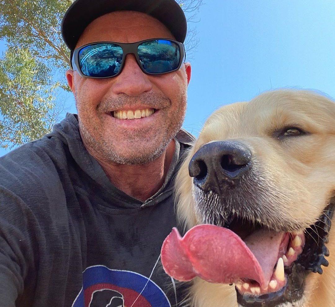 Joe Rogan smiling with his dog