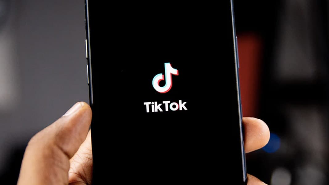 TikTok logo is shown on a smartphone.