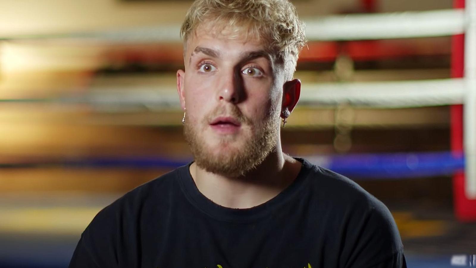 Jake Paul speaks to the camera near a boxing ring.