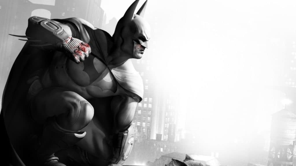 Batman sits on a ledge above Gotham city.