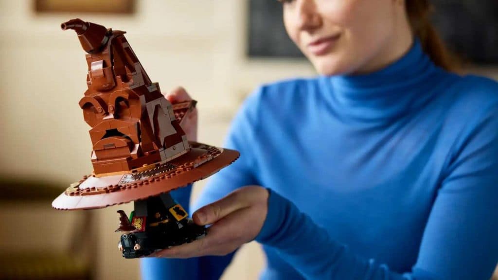 An adult with their LEGO Harry Potter Sorting Hat