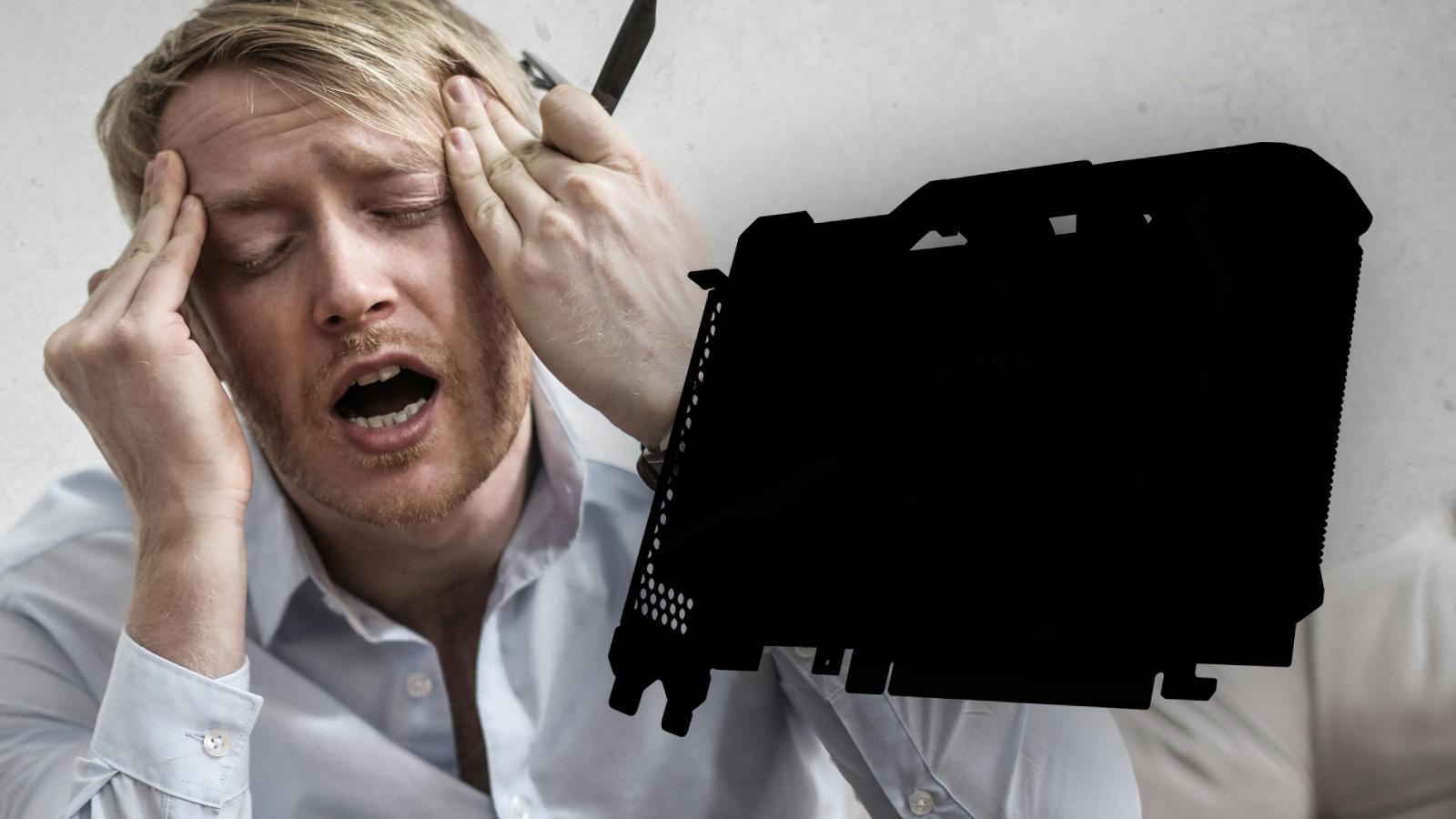 Man with head in hands next to mystery GPU