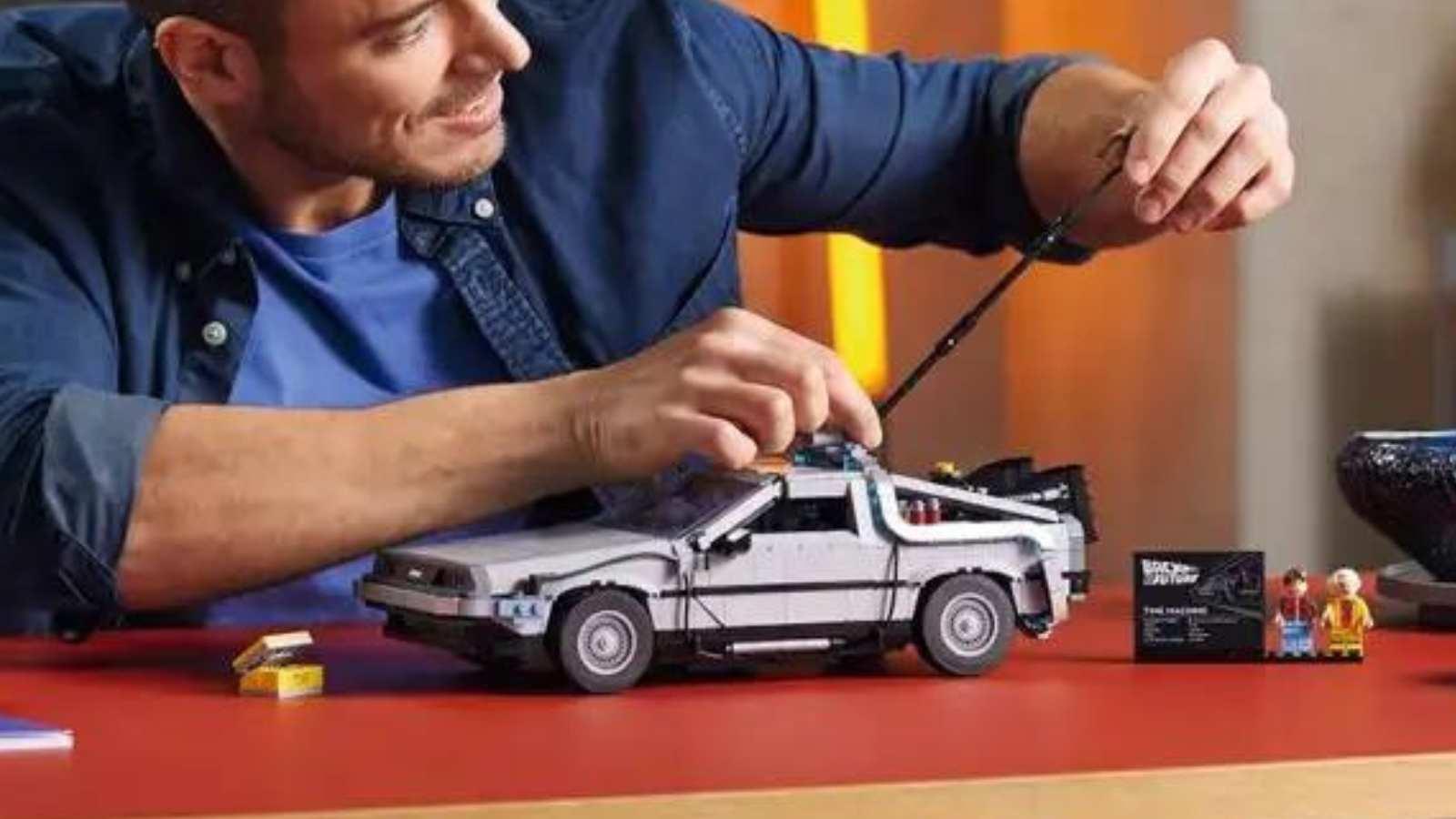 An adult with their LEGO Icons Back to the Future Time Machine set