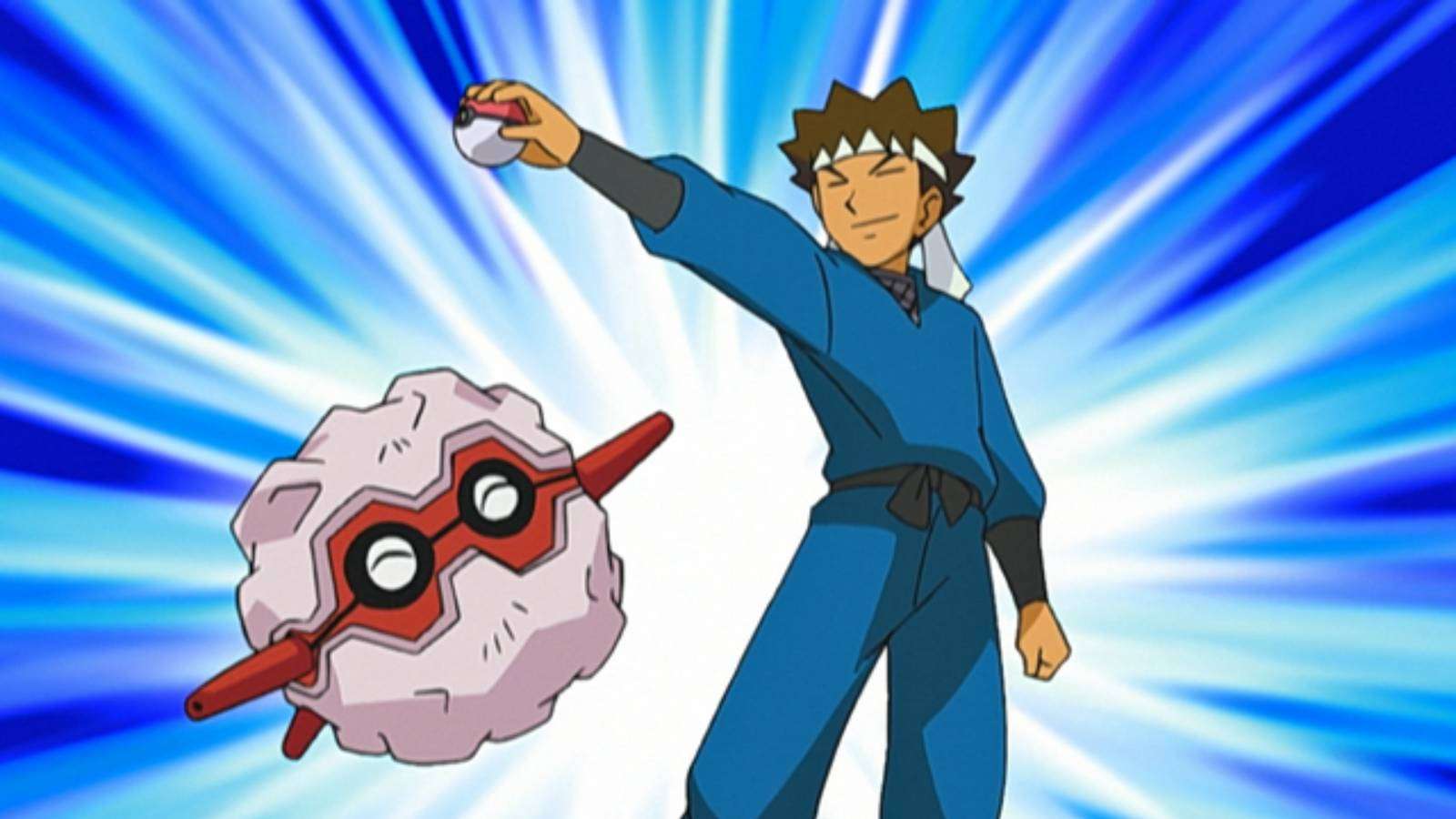 Pokemon character Brock stands posing with his Pokemon Forretress