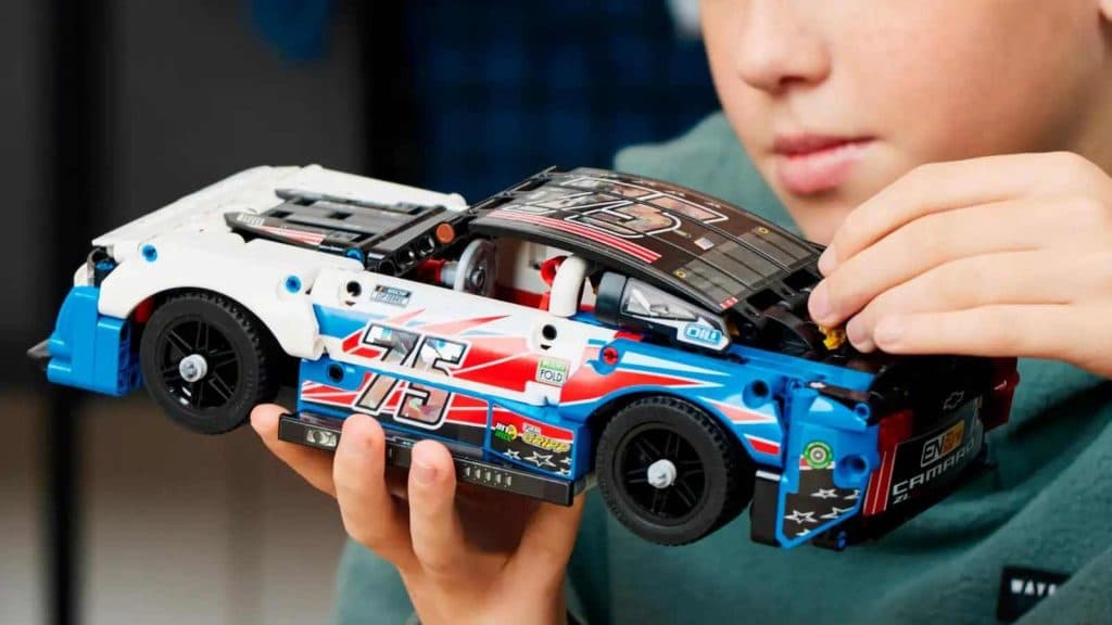 A child with their LEGO Technic NASCAR Next Gen Chevrolet Camaro ZL1 set