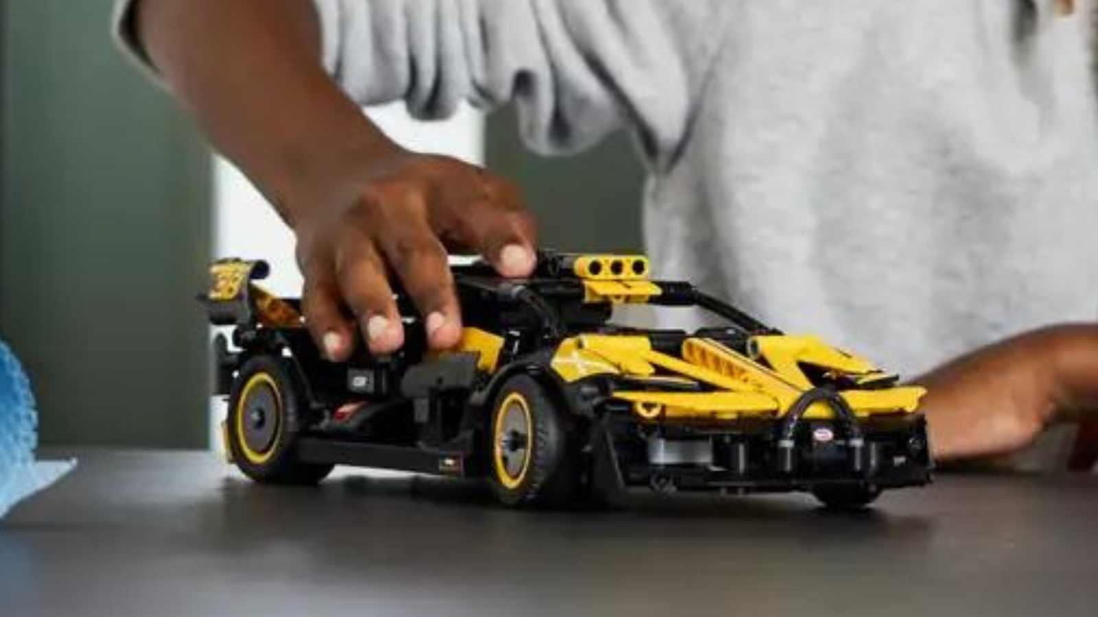A child playing with their LEGO-reimagined Bugatti Bolide