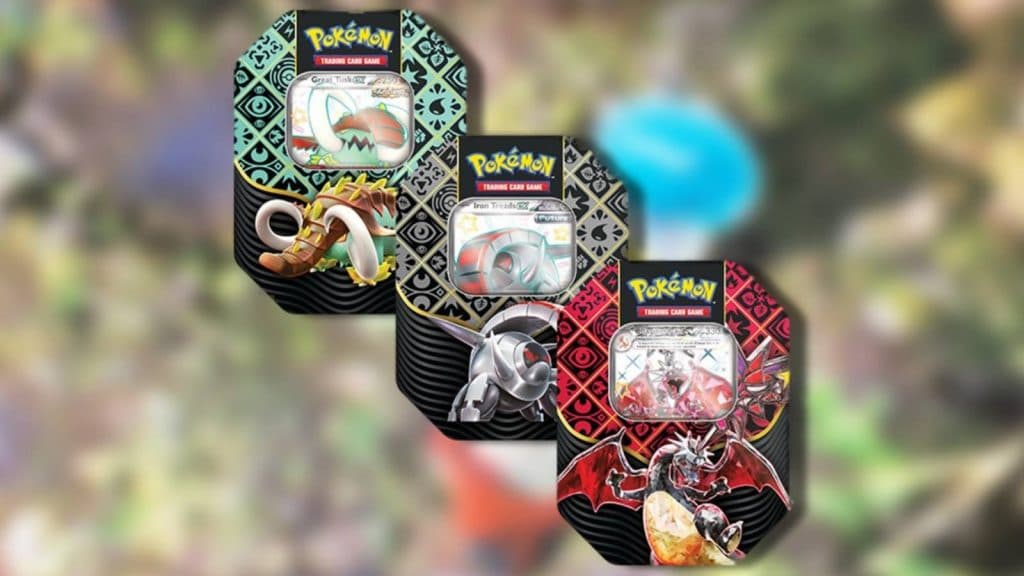 Pokemon TCG Paldean Fates tins are visible against a blurred background