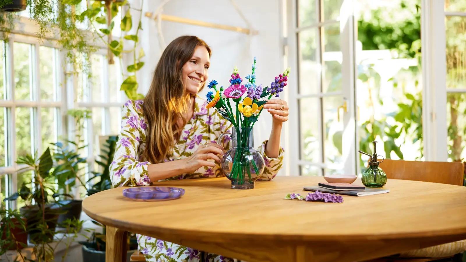 An adult arranging their LEGO Icons Wildflower Bouquet