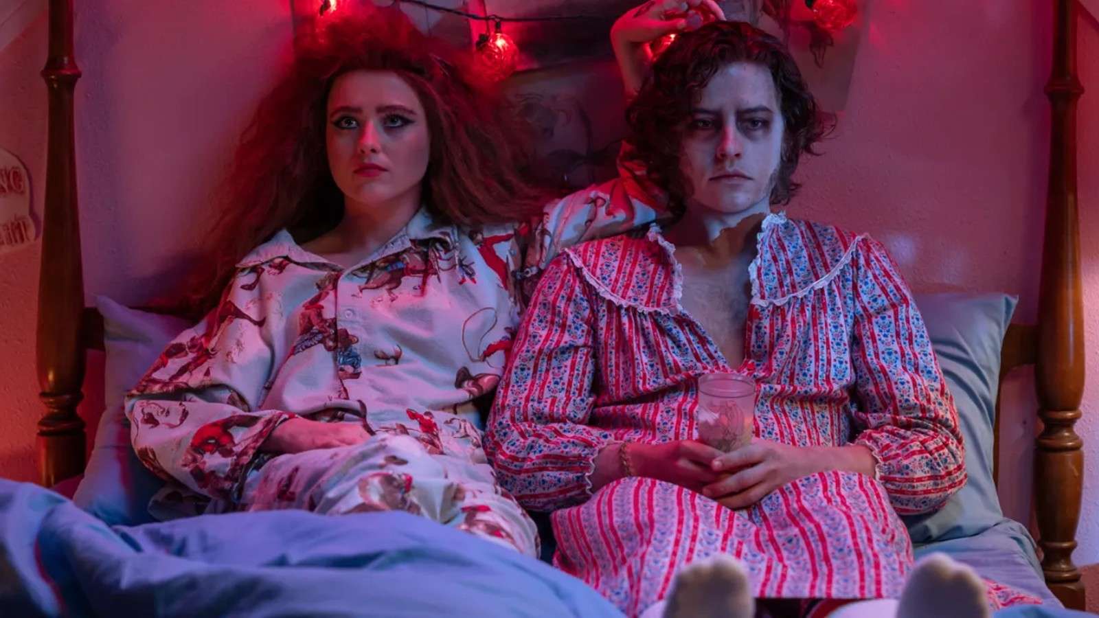 Kathryn Newton and Cole Sprouse lying in bed in Lisa Frankenstein.