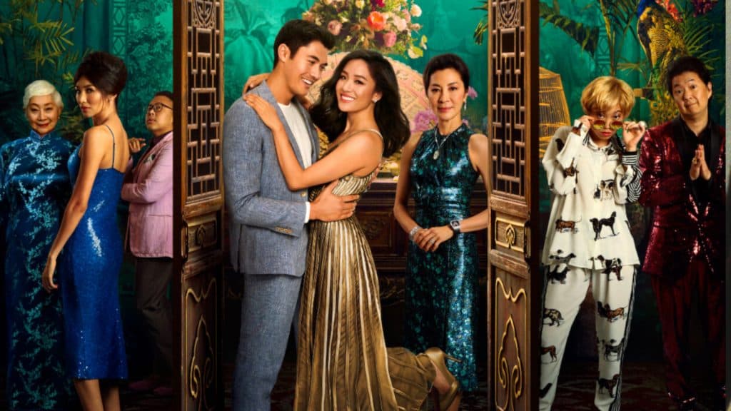 Rachel and Nick embrace while the cats of Crazy Rich Asians look on.