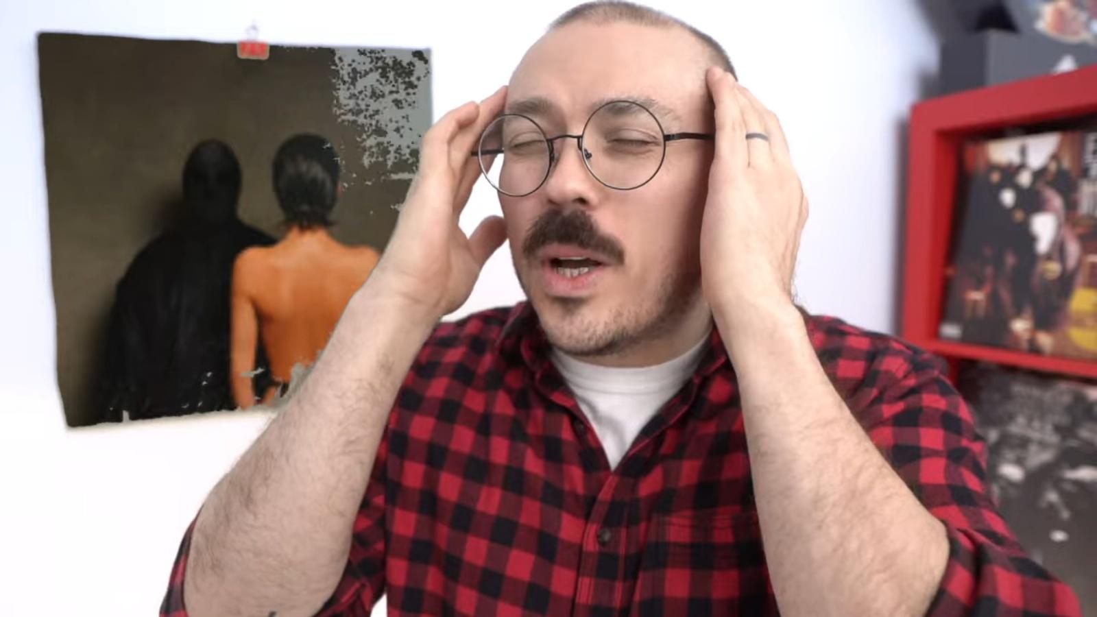 YouTube music critic Anthony Fantano looking stressed while reviewing a Kanye West album