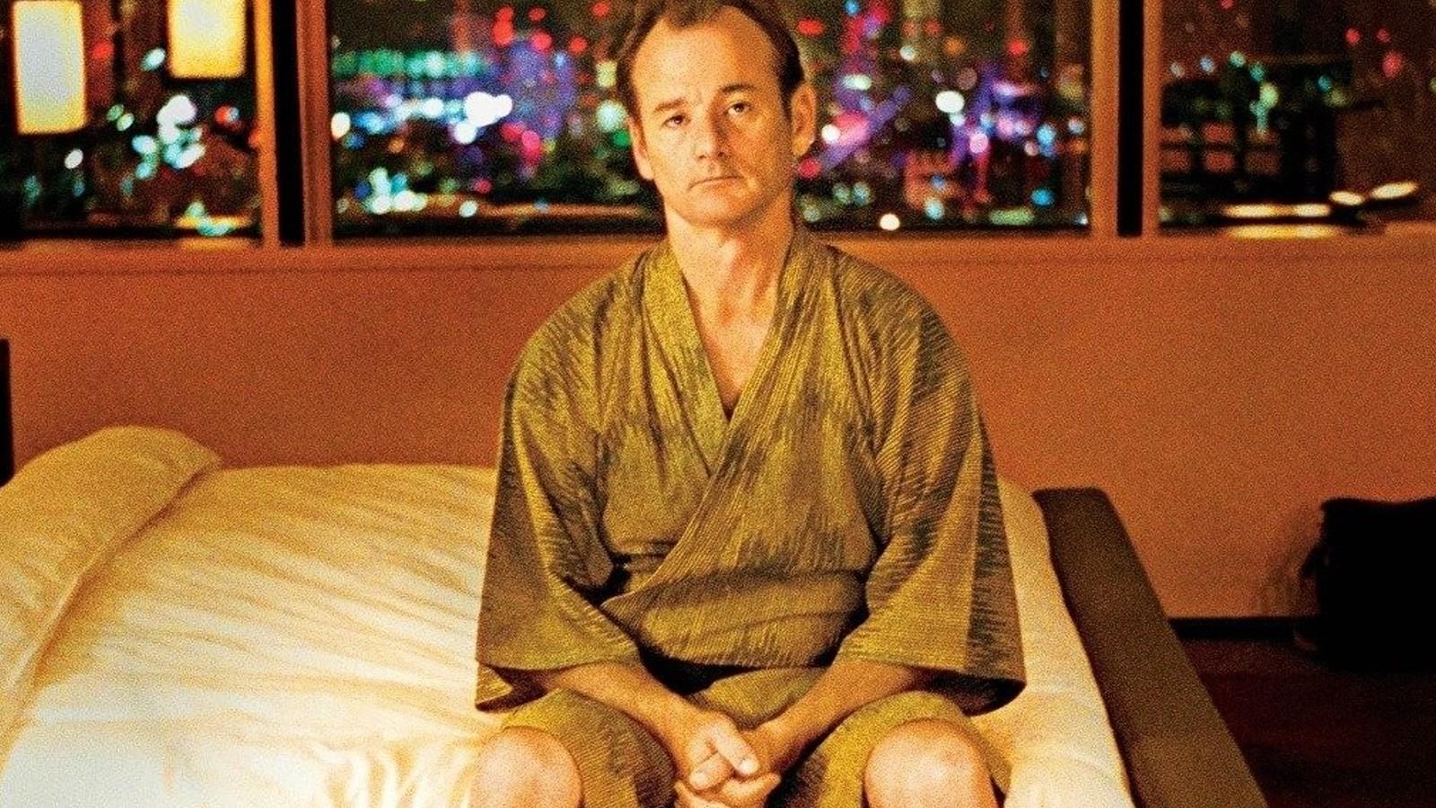 Bill Murray sitting on a bed in Lost in Translation.