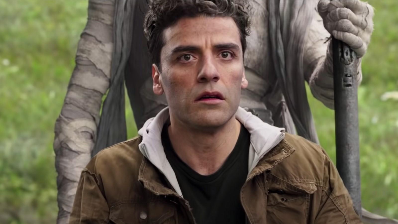 Oscar Isaac as Marc in Moon Knight standing in front of Moon Knight