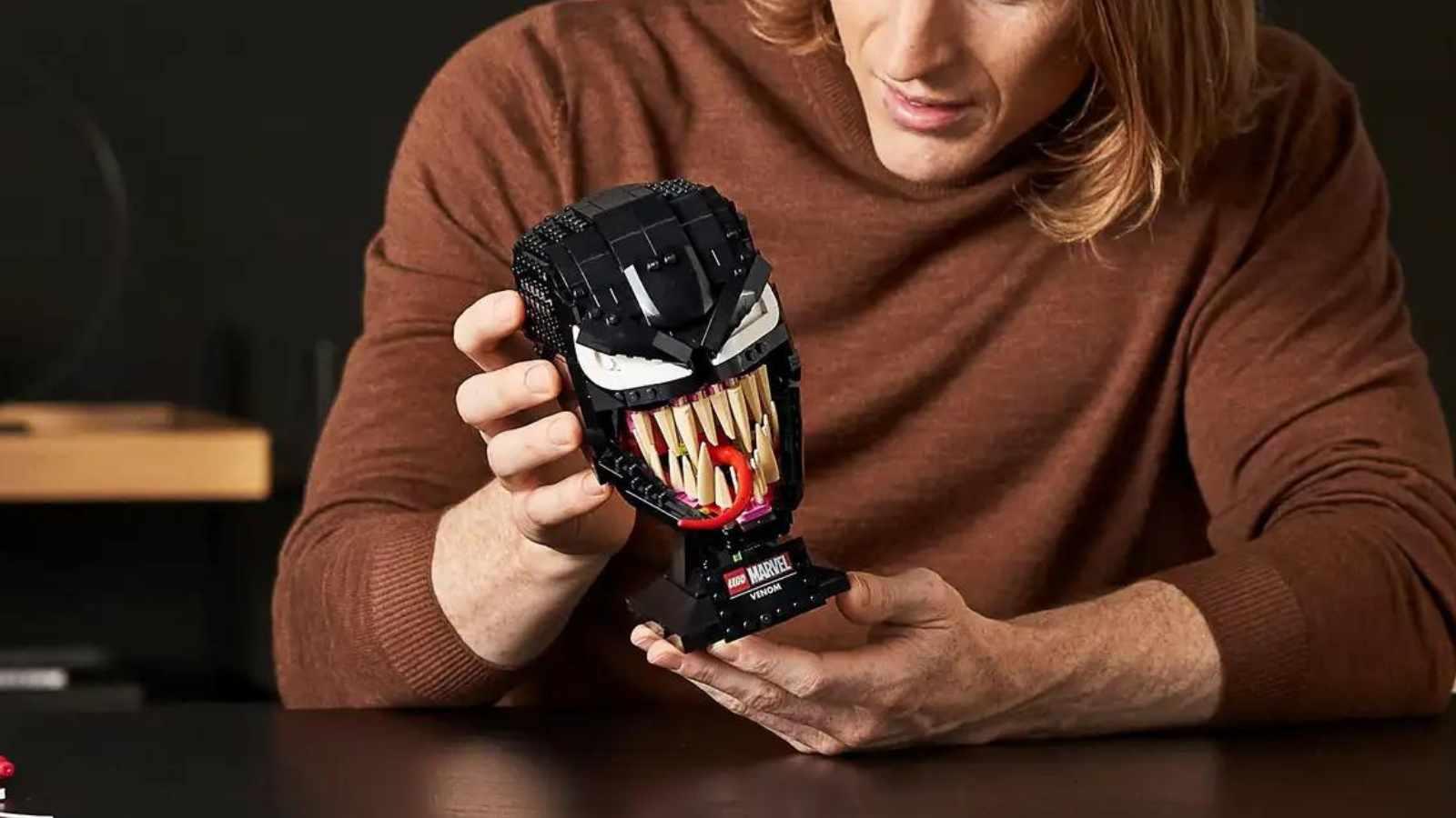 An adult with their LEGO Spider-Man Venom set.