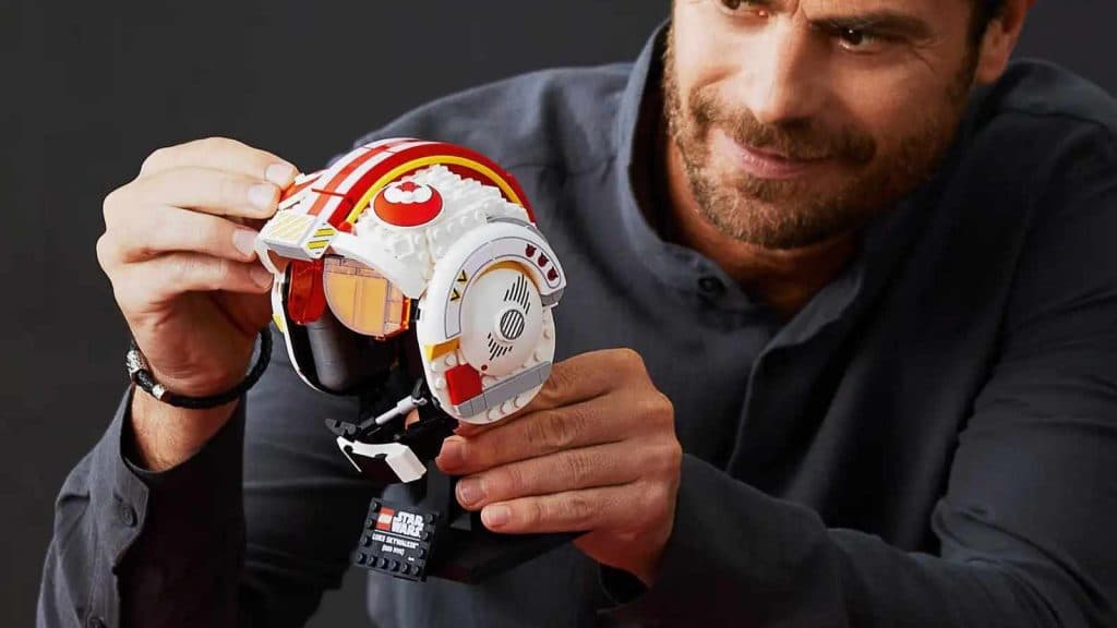 An adult with their LEGO-reimagined Luke Skywalker Red Five Helmet