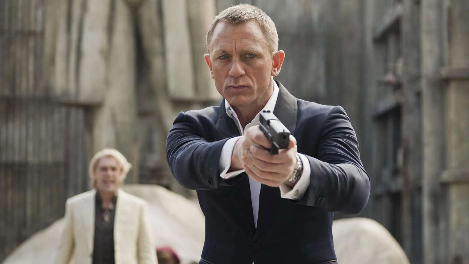 Daniel Craig as James Bond pointing a gun at someone