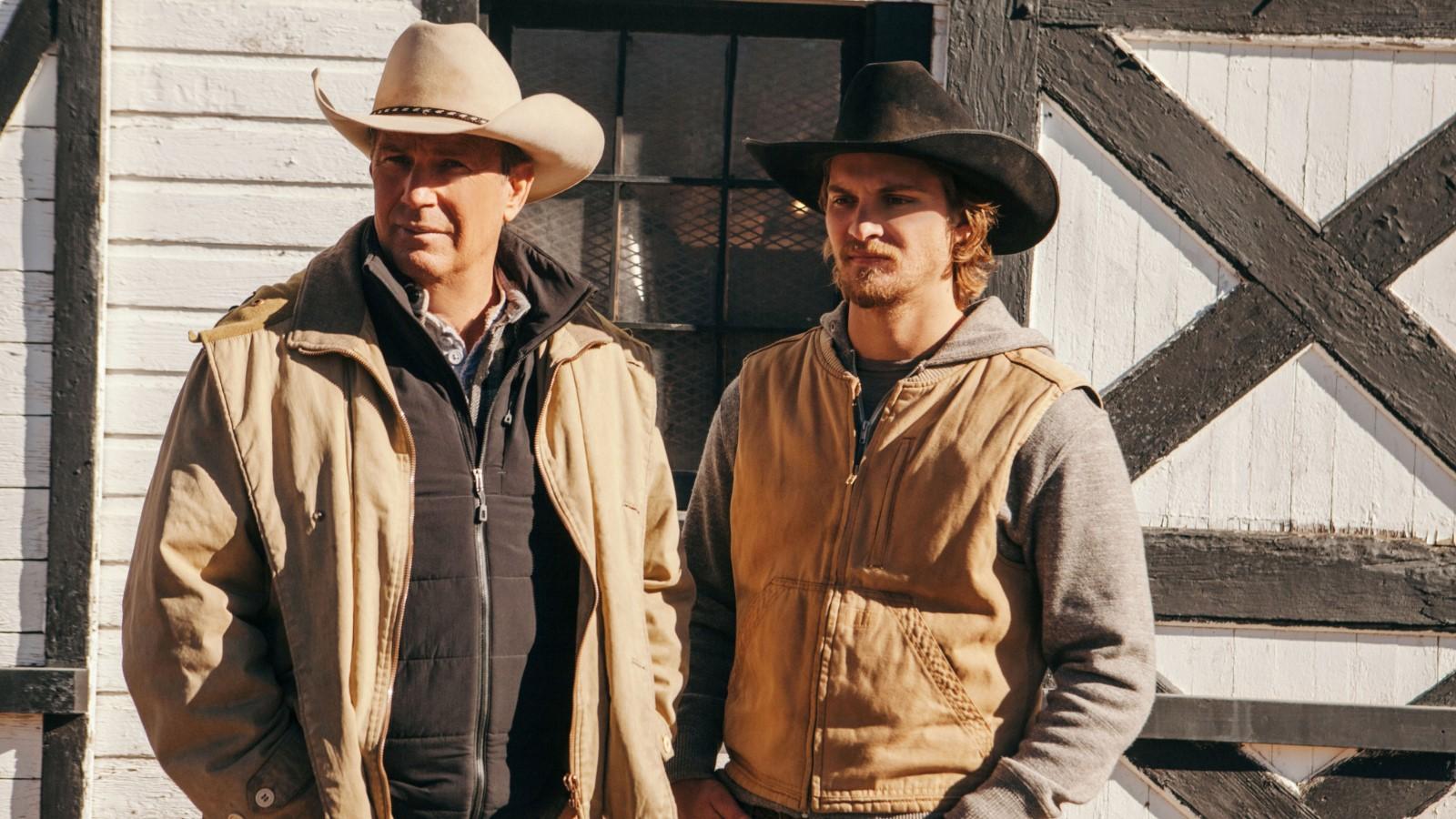 Kevin Costner and Luke Grimes as John and Kayce Dutton looking into the distance in Yellowstone