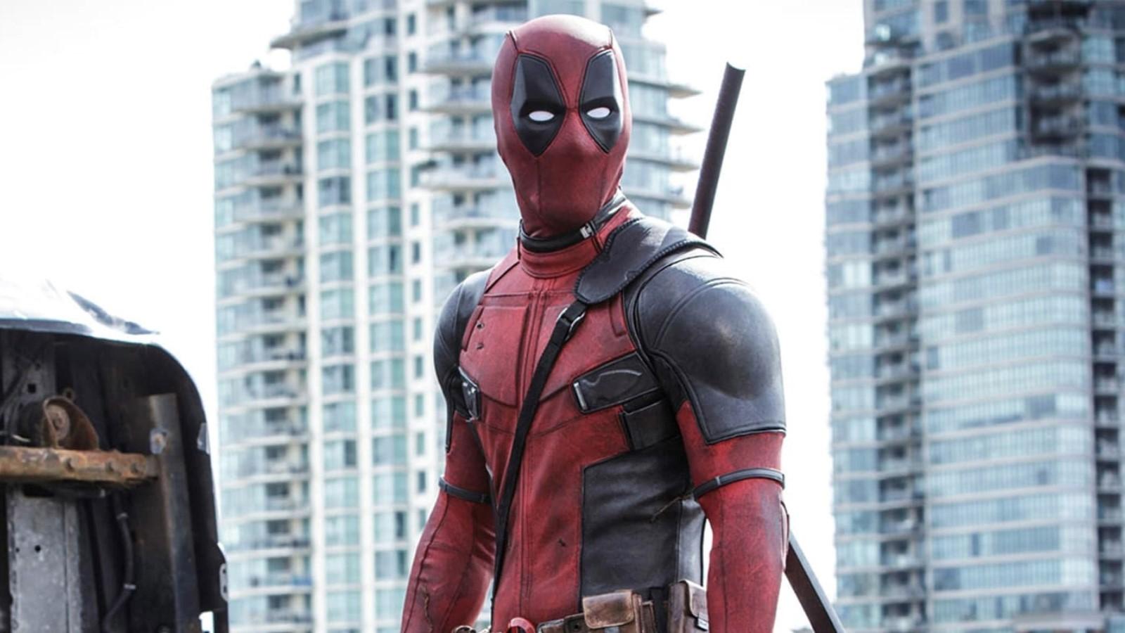 Deadpool standing in front of a building, looking outwards