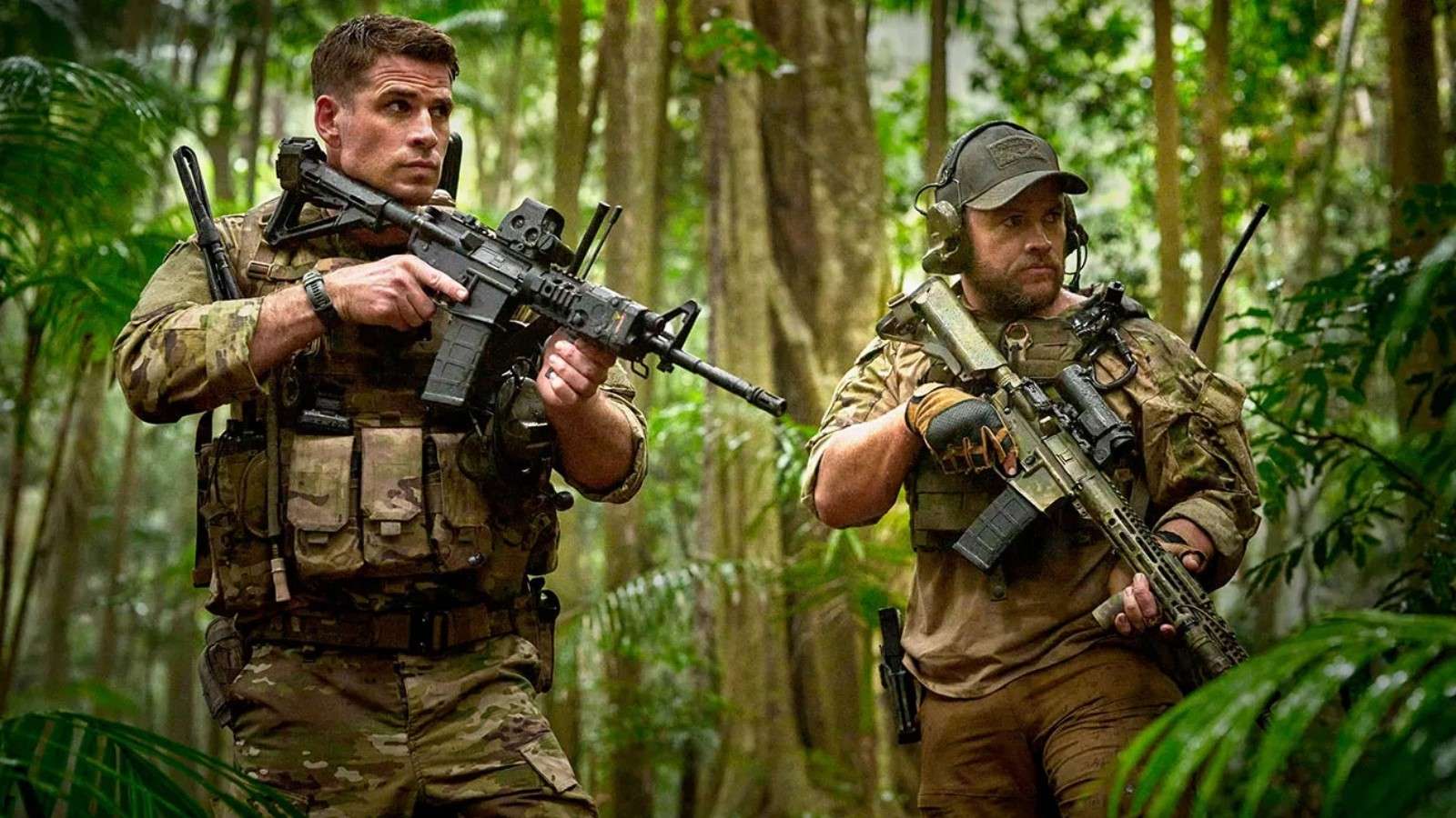 Land of Bad: Two men dressed in army uniforms hold their guns in the jungle