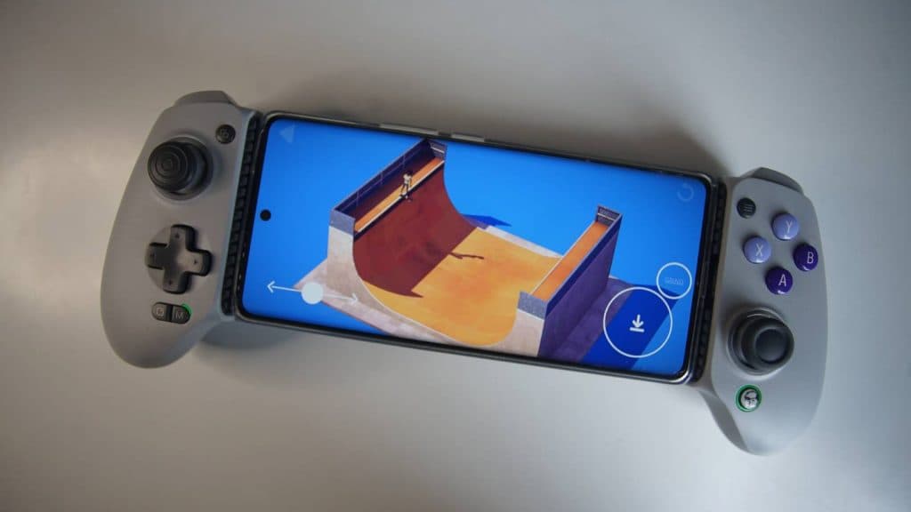 The GameSir G8 Galileo mobile controller is laid flat on a white desk with a phone fixed into it, playing The Ramp