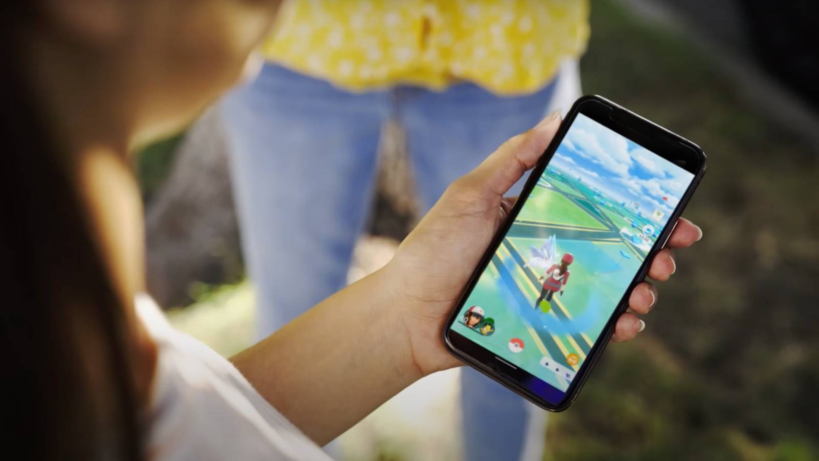 A Pokemon Go trainer holds their phone, with the screen showing the Adventure Incense activated
