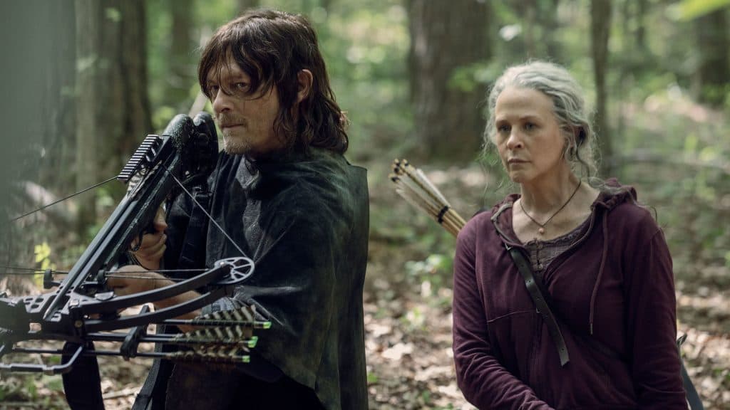 The Walking Dead: Daryl and Carol in the woods, Daryl holding a crossbow up