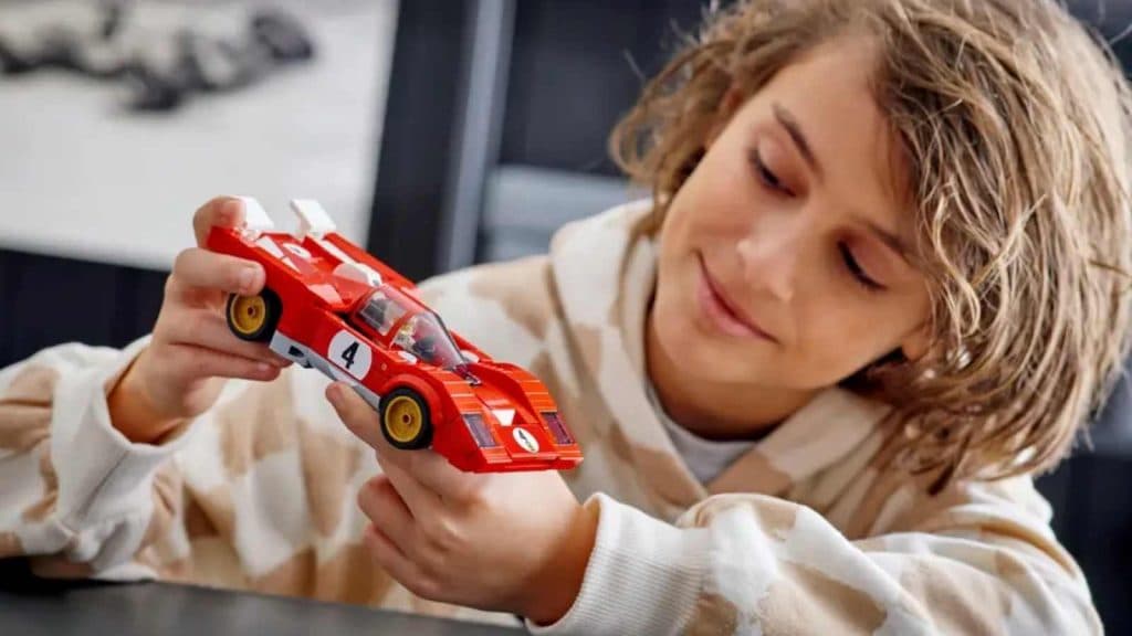 A child with their LEGO Speed Champions 1970 Ferrari 512 M