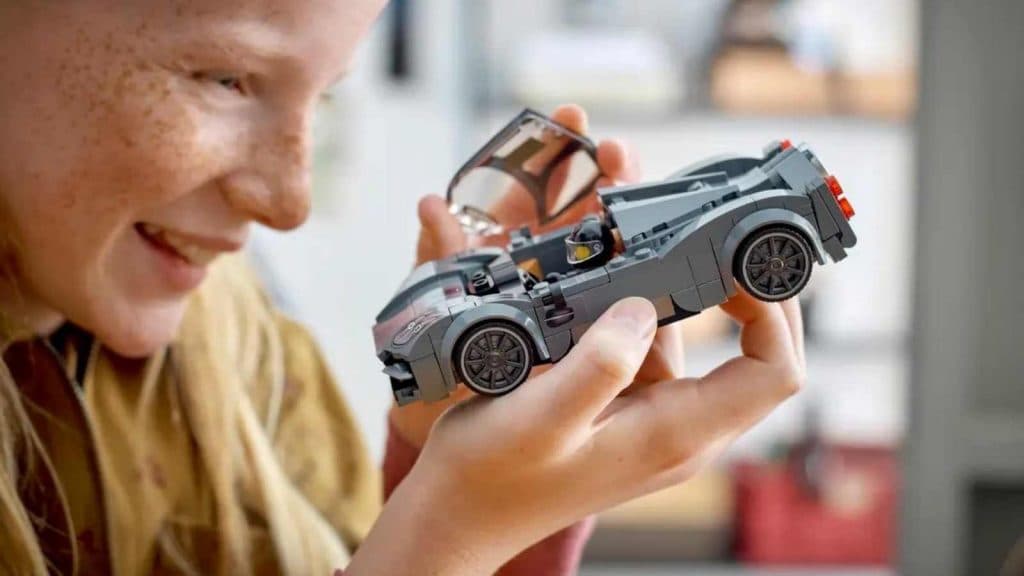 A child with their LEGO Speed Champions Pagani Utopia