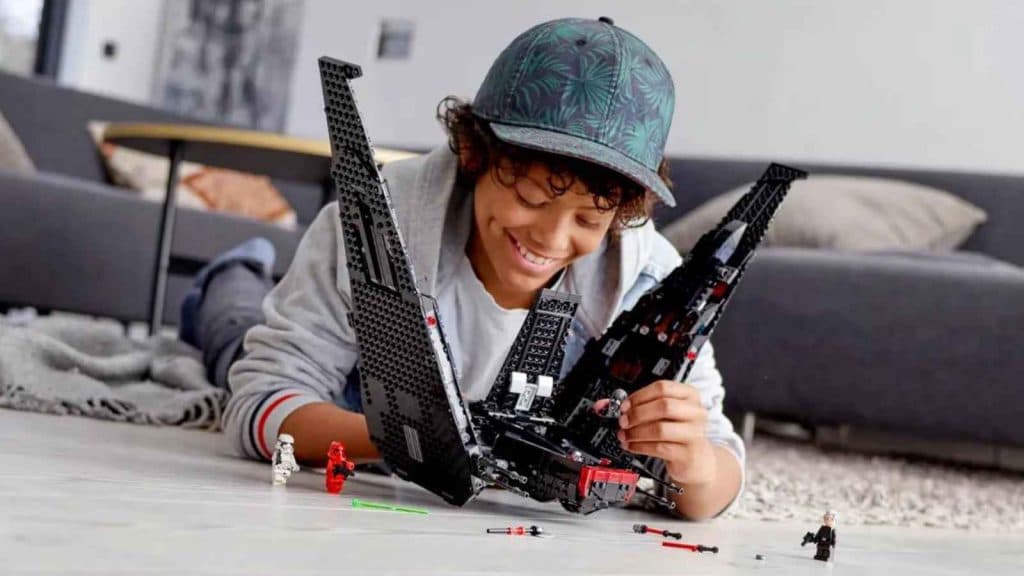 A child playing with their LEGO Star Wars Kylo Ren's Shuttle