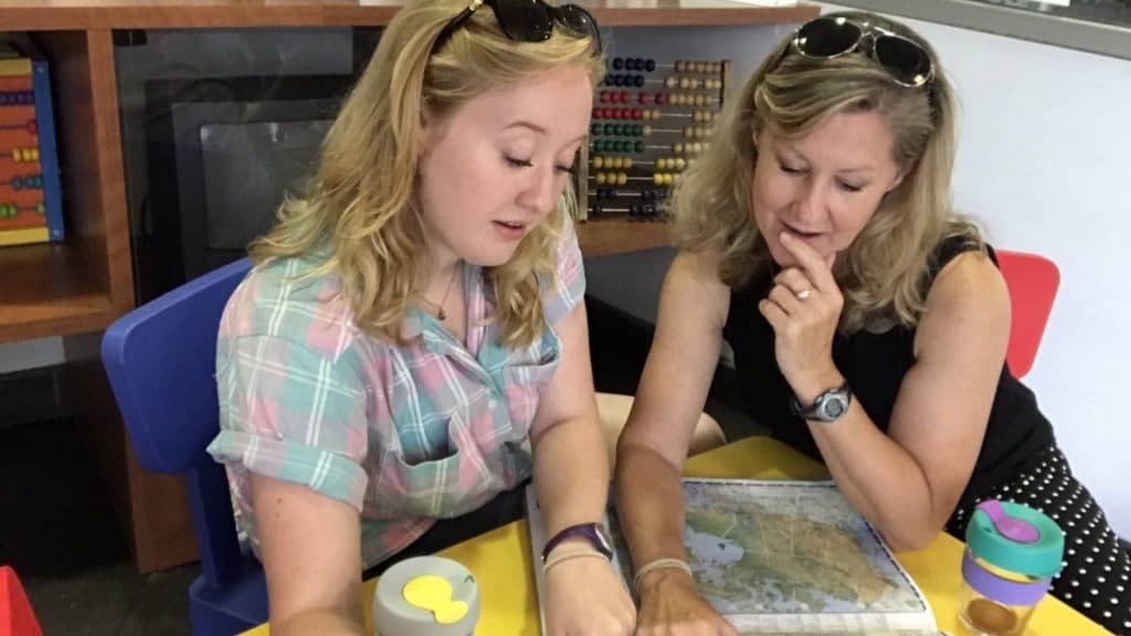 Veronica Taylor and daughter Rena Taylor look at a map on a table