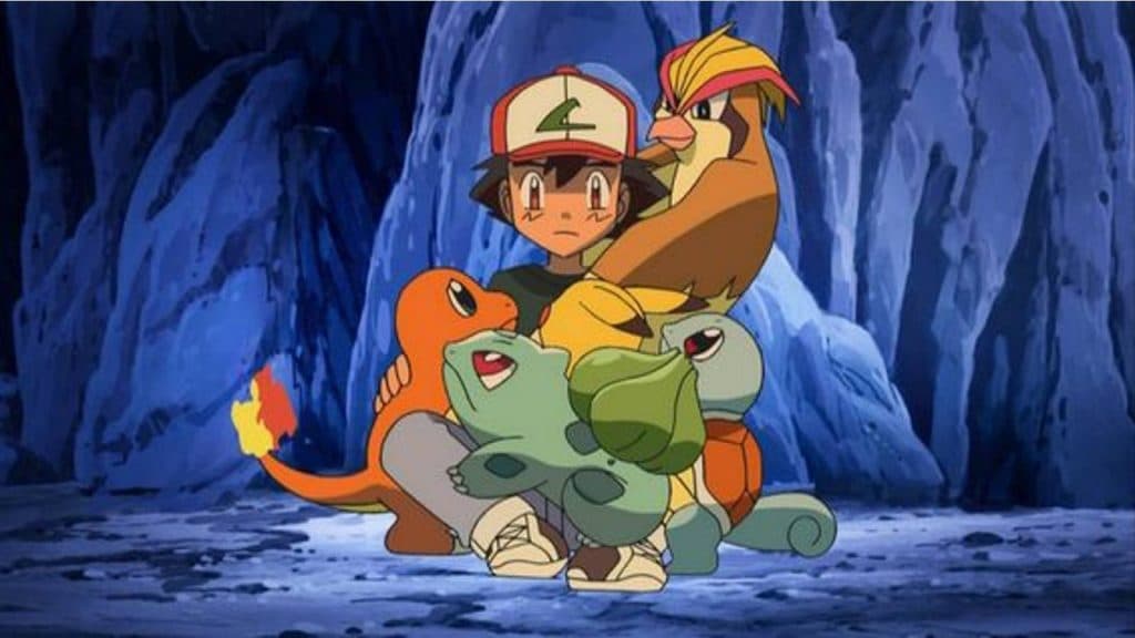 Ash Ketchum cuddles up with multiple Pokemon in a cave to keep them warm