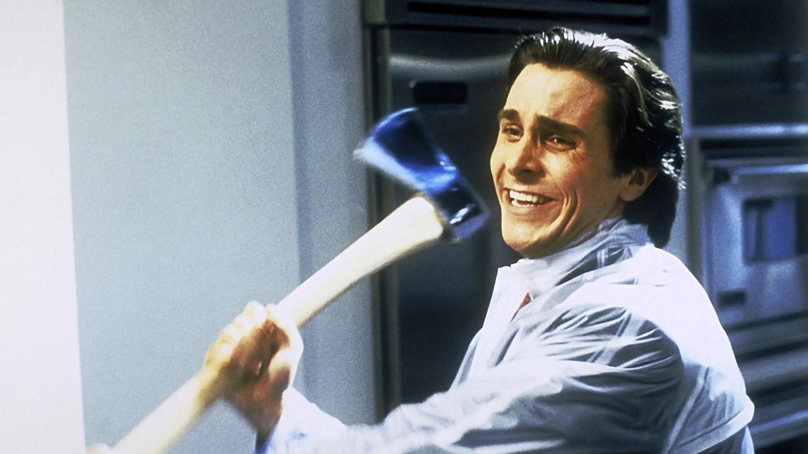 Christian Bale as Patrick Bateman in American Pyscho, wearing a raincoat and holding an axe