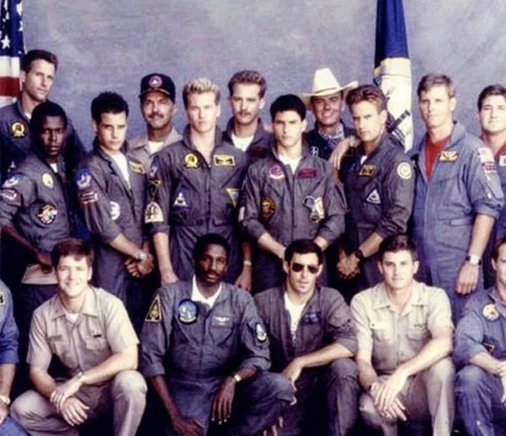 Cast photo of the original Top Gun movie, with the characters in uniform